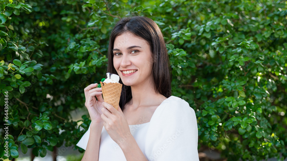 Portrait of happy young woman with delicious ice cream in waffle cone outdoors. Portrait of happy young woman with delicious ice cream in waffle cone outdoors.