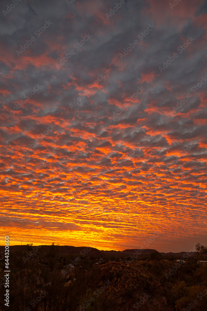 An orange sunset reflecting on clouds in outback Australia