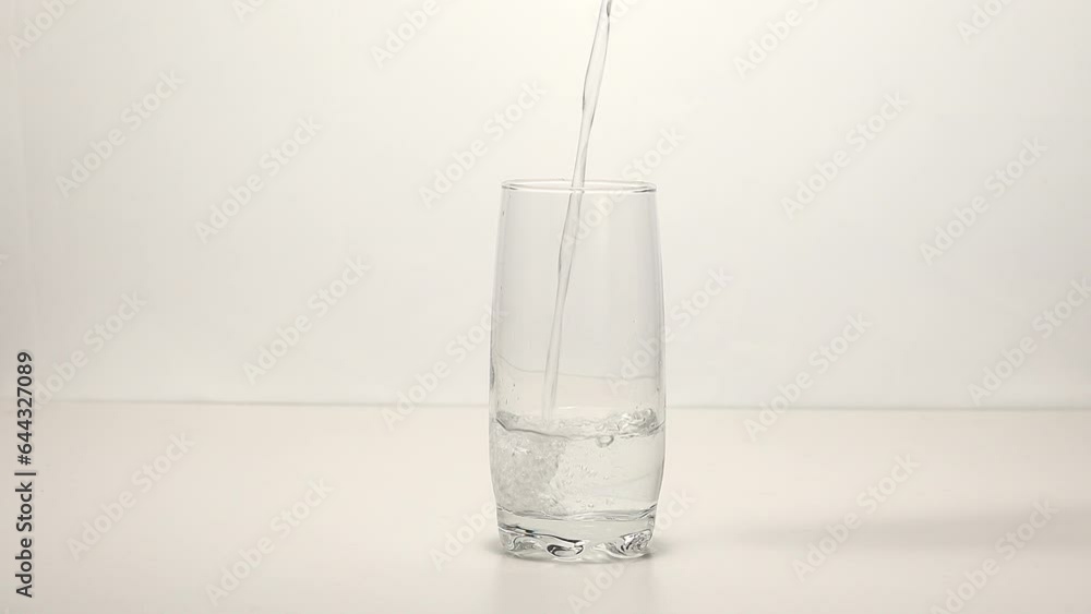 Pouring water into a clear glass Pouring water into a clear glass