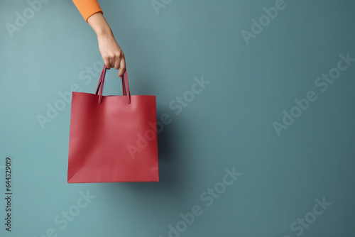 beautiful woman hand holding colorful empty shopping bags.online shopping and black friday concept.Created with Generative AI technology.