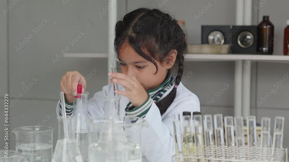 asian kid learning and doing chemistry experiments in lab asian kid learning and doing chemistry experiments in lab