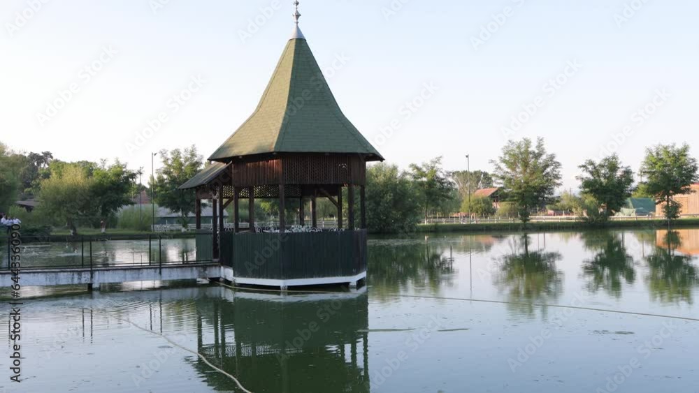 Gazebo on dock in middle of small pond at event venue, ready for wedding Gazebo on dock in middle of small pond at event venue, ready for wedding