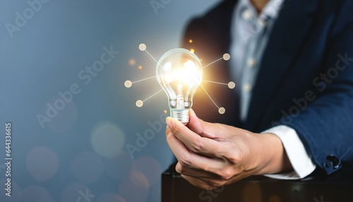 person holding light bulb with idea