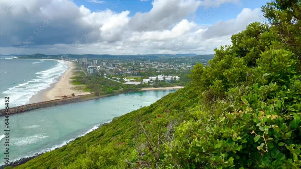 View over Tallebudgera Creek where it meets the Pacific Ocean on the Gold Coast in Queensland. Branches blowing in the wind and clouds rolling in on the coast. View over Tallebudgera Creek where it meets the Pacific Ocean on the Gold Coast in Queensland. Branches blowing in the wind and clouds rolling in on the coast.