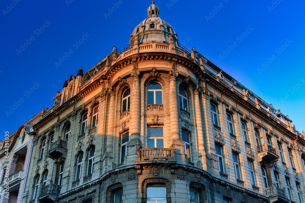 Fototapeta premium Beautiful architecture of Piotrkowska Street in Lodz city at sunrise. Poland
