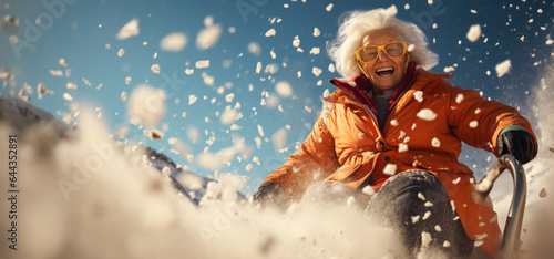 Wrapped in winter's embrace, a grandmother glides down a snowy hill on a sled, her heart filled with joy and excitement.