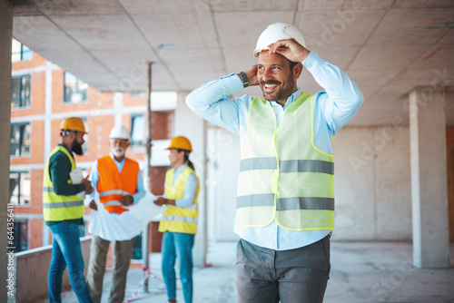 Portrait of man architect at building site. Confident construction manager in formal clothing wearing white hardhat. Successful civil engineer at construction site with copy space. photo