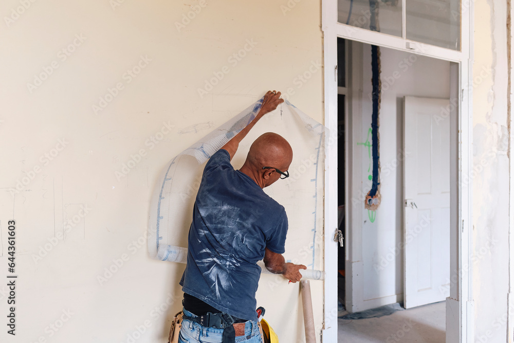 Construction worker with mesh sheet at site
