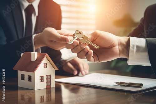 Real estate agent handing house key to buyer after signing rental least contract during house loan meeting. Successful property sale purchase agreement for new home ownership. Entity photo
