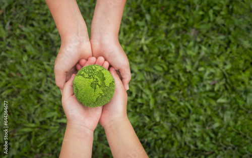 world environment day hand holding green globe on green background Environmental protection and sustainable environment Concept of cooperation to maintain a clean world