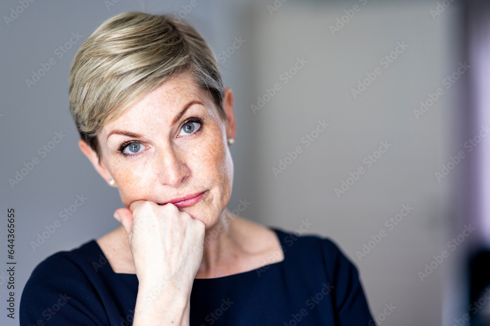 Mature woman with hand on chin Mature woman with hand on chin