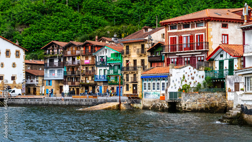 View of an old town full of colourful houses sorroudned by sea with a boat floating