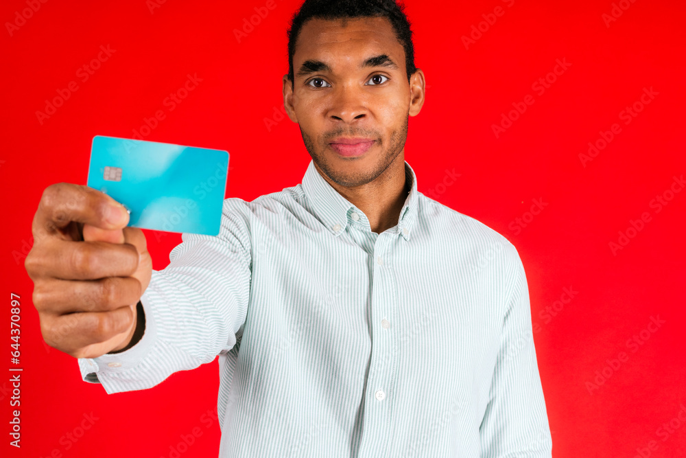Man showing credit card against red background Man showing credit card against red background