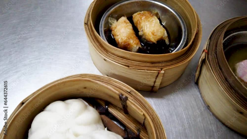 Dim sum, Dim Sum on the wooden table, top view and space for text input , Dim Sum (Chinese food) in steamed bamboo Dim sum, Dim Sum on the wooden table, top view and space for text input , Dim Sum (Chinese food) in steamed bamboo