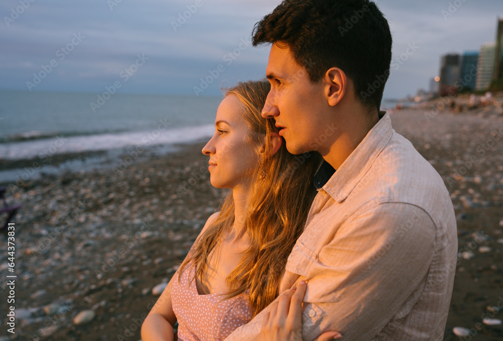 Thoughtful romantic couple embracing at beach Thoughtful romantic couple embracing at beach