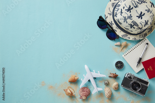 top view of travel gadgets on blue background for travel concept