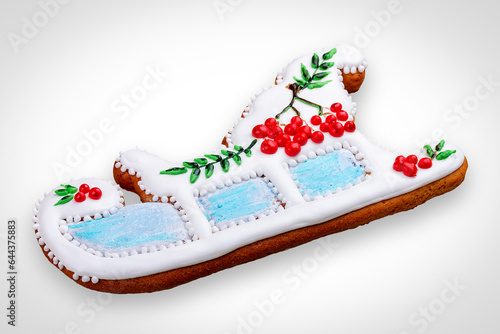 New Year's gingerbread in the shape of a sleigh. A festive treat. Isolated on a white background.