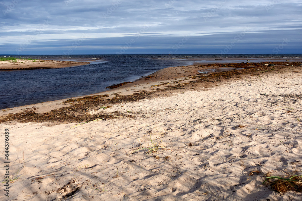 Northern seascape. Tersky coast of the White Sea. Murmansk region, Russia. The White Sea coast in Karelia in summer. Low tide. Northern seascape. Tersky coast of the White Sea. Murmansk region, Russia. The White Sea coast in Karelia in summer. Low tide.