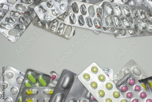 Full and empty packaging of pills, top view, space for text