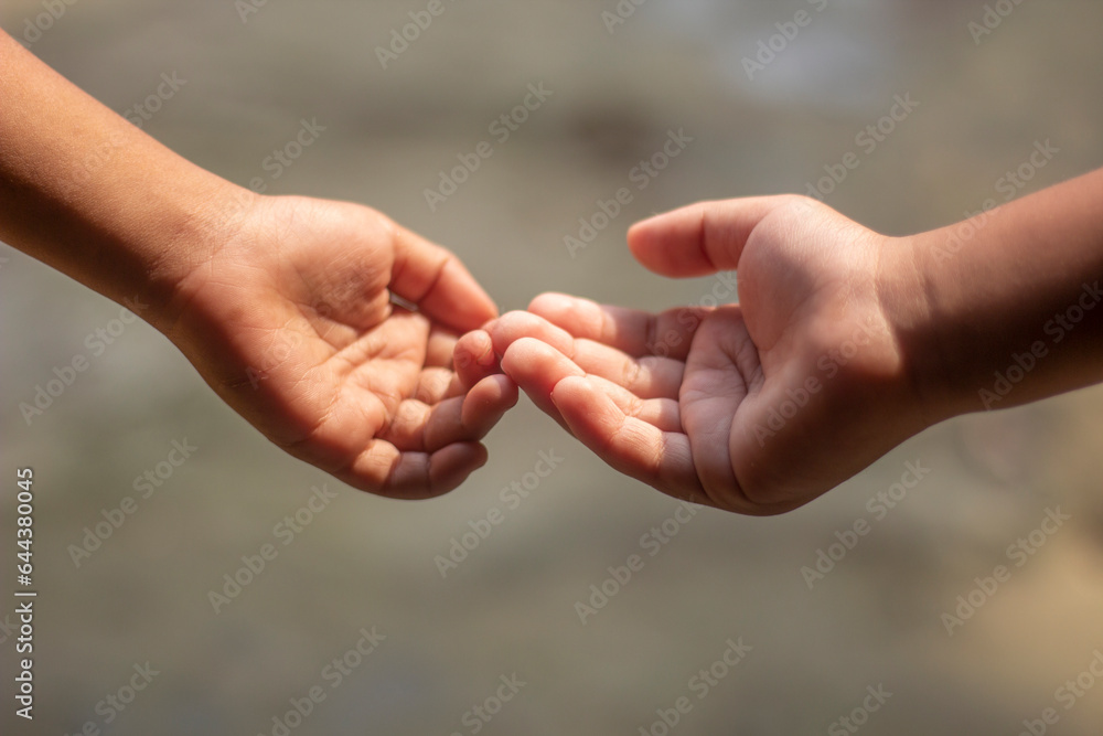 Two boys holding each other's hands expressing love Two boys holding each other's hands expressing love