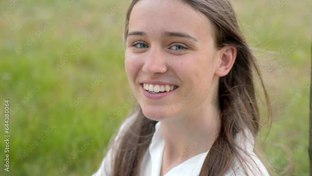 Close-up portrait of young Caucasian woman smiling into camera Close-up portrait of young Caucasian woman smiling into camera