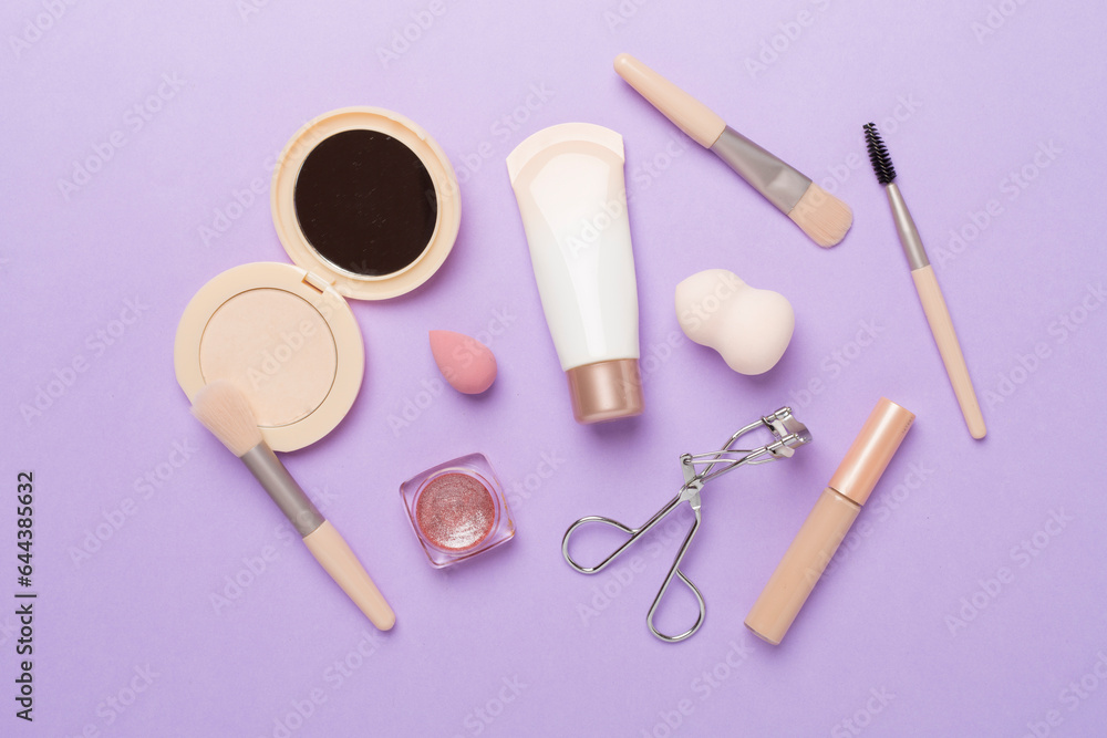 Flat lay with makeup products and tools with flowers on color background Flat lay with makeup products and tools with flowers on color background
