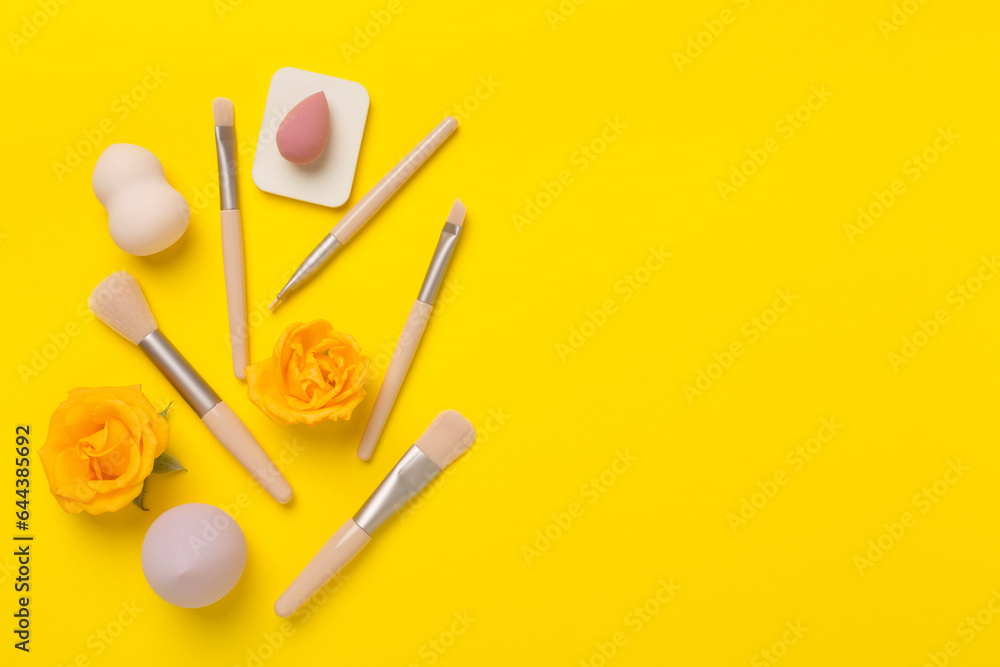 Makeup brushes and sponges on color background, top view Makeup brushes and sponges on color background, top view