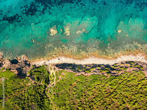 Top view of the turquoise sea near the rocky shore. Italy Sardinia