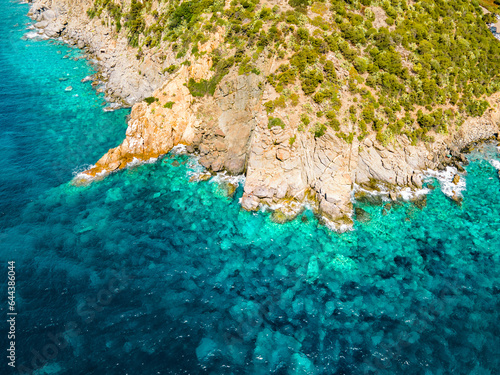 Top view of the crystal clear sea near the rocky shore. Italy island Sardinia