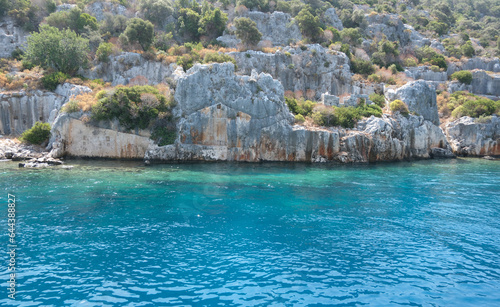 Ruins of Lycian civilizations in the Mediterranean. Rock carved city. Kekova sunken city. Turquoise sea. Antalya, Türkiye.