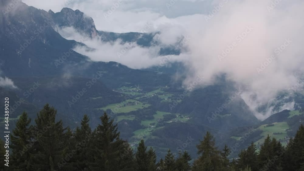 Morning on Sarentino Alps with views over pine trees to mountain peaks and rising clouds, Italian Alps Morning on Sarentino Alps with views over pine trees to mountain peaks and rising clouds, Italian Alps