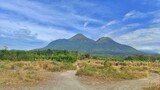 Natural outdoor view of 'Penanggungan' mountain from Indonesia with dirt road during sunny day