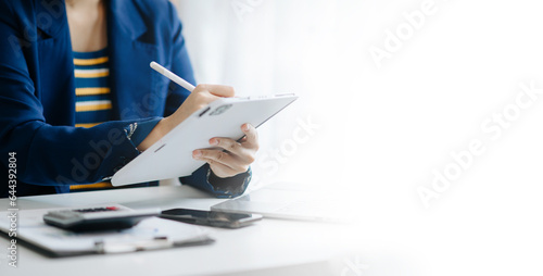 business documents on office desk with laptop and smart phone and graph business diagram and man working