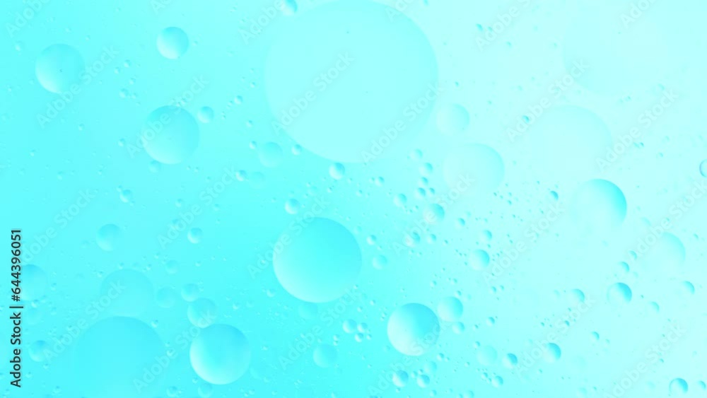Slow Motion of Flowing Oil Bubbles in Water. Abstract Colored Background. Filmed on High Speed Cinema Camera. Slow Motion of Flowing Oil Bubbles in Water. Abstract Colored Background. Filmed on High Speed Cinema Camera.