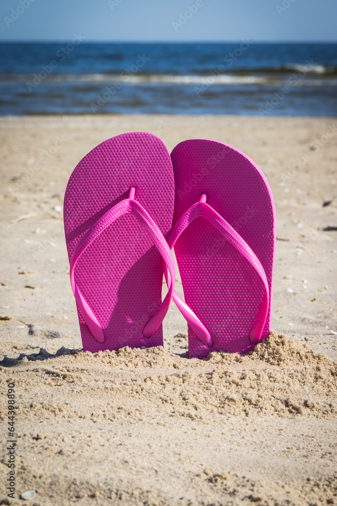 Flip flop on beach. Accessories for relax on sand. Summer vacation