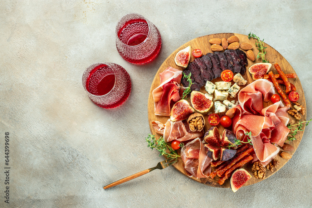Appetizers, antipasti snacks and red wine in glasses. cured ham, prosciutto slices with figs and cheese. banner, menu, recipe place for text, top view