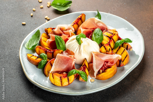 Grilled peach salad with mozzarella, prosciutto ham, basil, olive oil, Restaurant menu, dieting, cookbook recipe top view