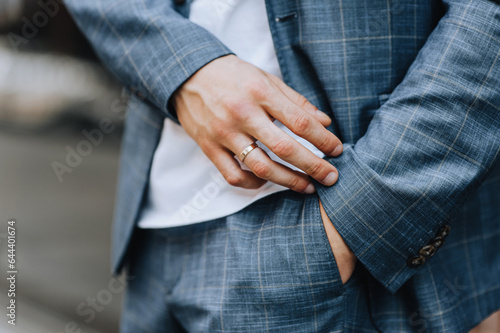 Stylish man, businessman stands outdoors in a blue plaid jacket, suit. Close-up photography, portrait, business.
