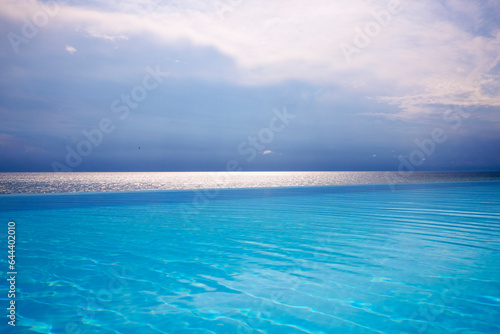 Beautiful landscape with an infinity pool by the sea.