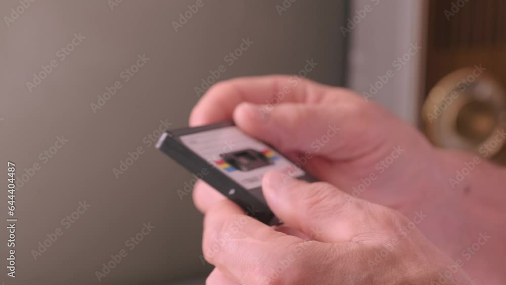Audio Compact Cassette in mature male Hand, man holding vintage devices from 60s, 70s, common media on magnetic tape, Vintage technology, Listening to music, Audio technology nostalgia Audio Compact Cassette in mature male Hand, man holding vintage devices from 60s, 70s, common media on magnetic tape, Vintage technology, Listening to music, Audio technology nostalgia