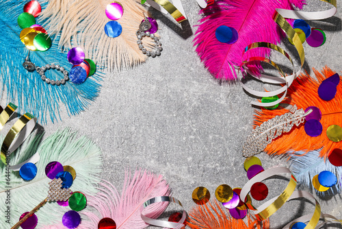 Feathers, confetti and serpentine on gray background, space for text