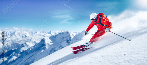 Skier skiing downhill in high mountains on a sunny day. Ski resort with snow at winter.
