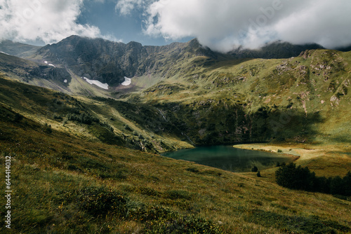 High mountain glacial lake. Mountains covered with clouds. Caucasus mountains
