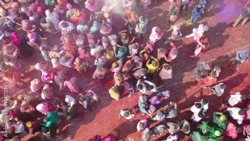 Barsana, India - 28 February 2023: Aerial view of people celebrating the holy colour festival in the street in Barsana, Uttar Pradesh, India. photo