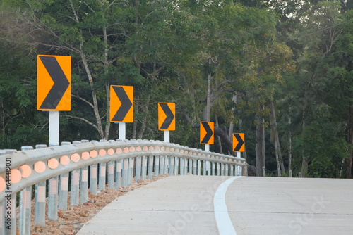 The sharp bend signs are included black and yellow on the road up to the hill in Thailand , to be careful drive 