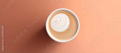 YinYang or Dao shaped coffee foam on top of a paper cup isolated pastel background Copy space