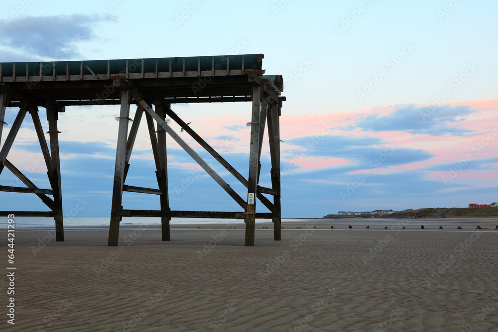 Derelict wooden pier on a beach at Hartlepool, England, UK.