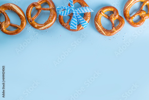 Oktoberfest background with bavarian pretzels and checkered ribbon tied with bow