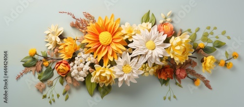 Yellow flowers arranged in a bouquet with a mix of chrysanthemum dahlia and orchid in vibrant colors of yellow orange and green set against a isolated pastel background Copy space