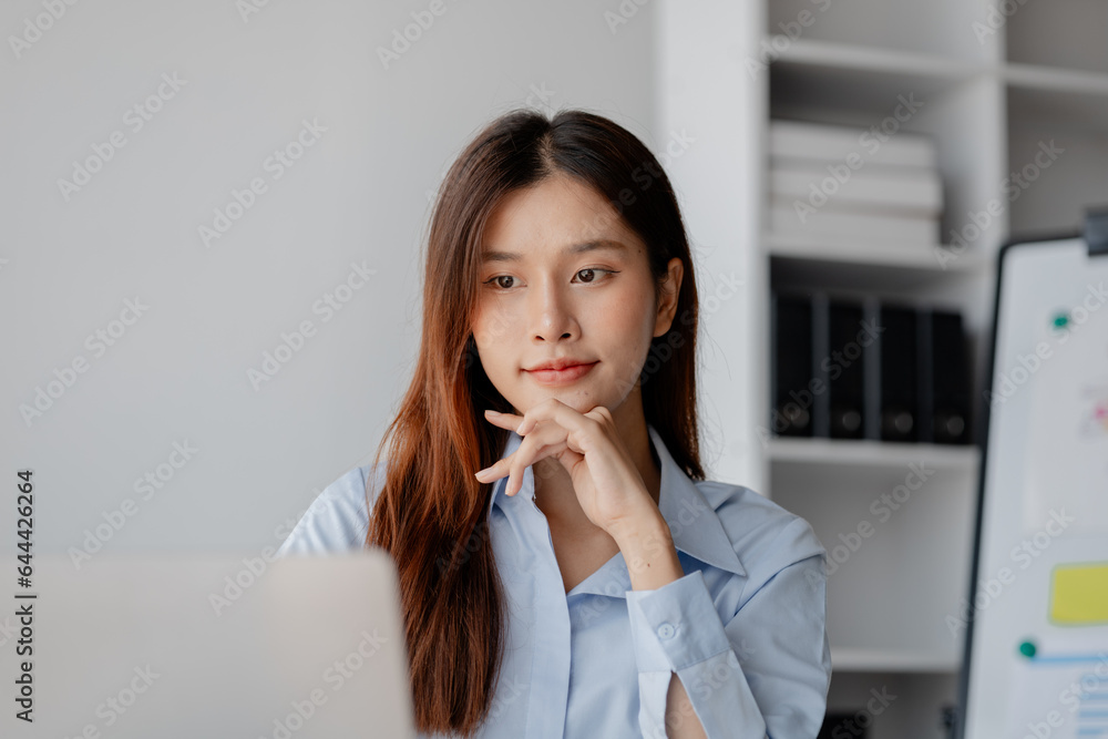 Asian woman sitting in startup company office, marketing analyzing and planning marketing for company growth, sales management. Businessman concept, marketing planning. Asian woman sitting in startup company office, marketing analyzing and planning marketing for company growth, sales management. Businessman concept, marketing planning.